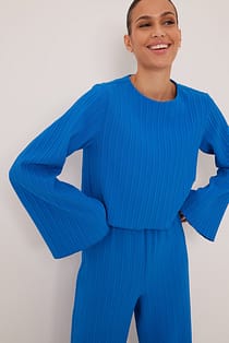 Plissert bluse med trompetermer