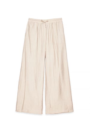 Beige weite, fließende Hose mit mittlerer Taille