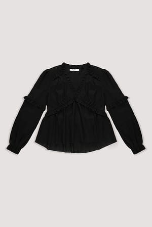 Black Strukturert bluse med lange ermer og volanger